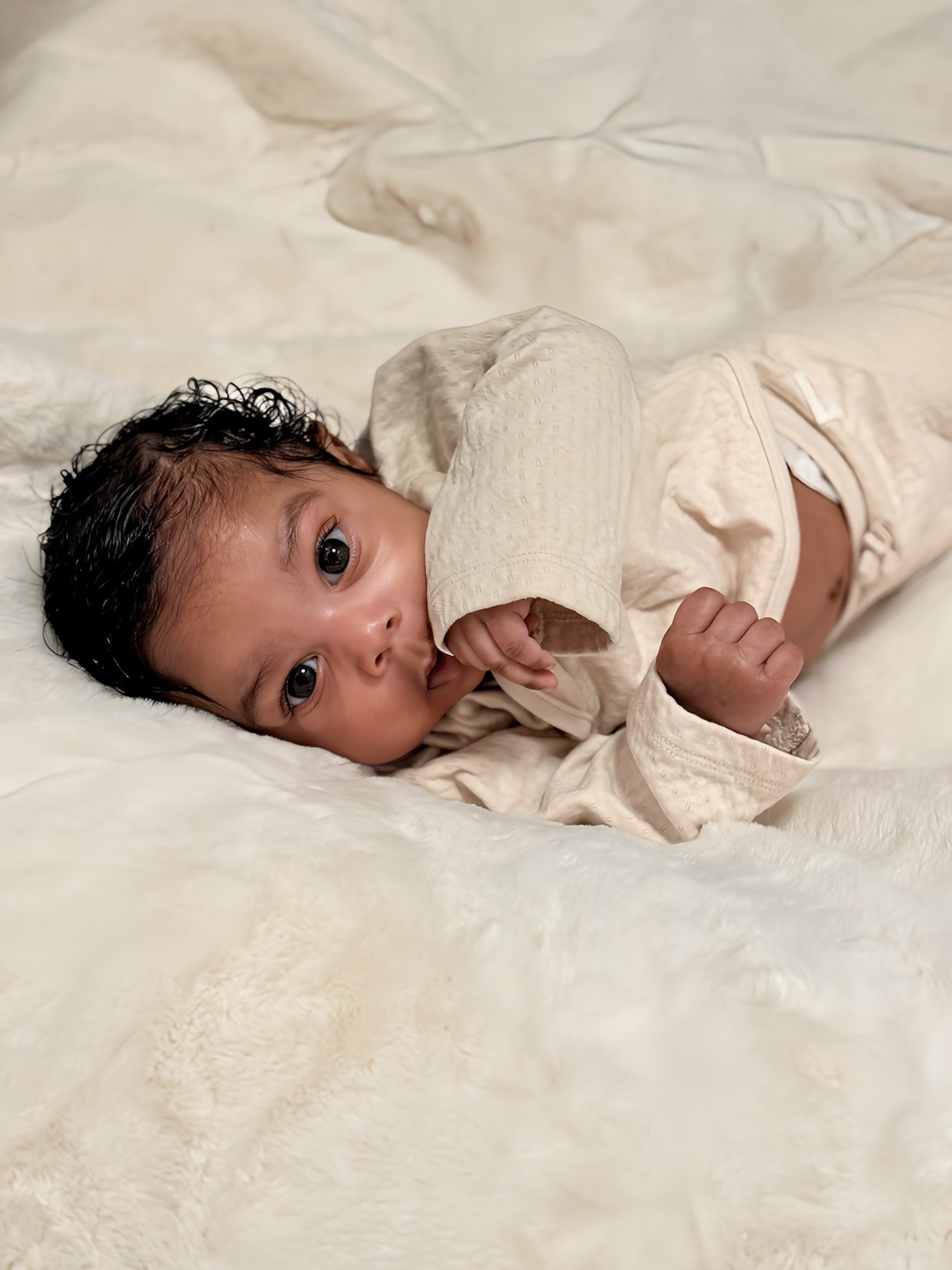 Chloé resting on soft ivory bedding